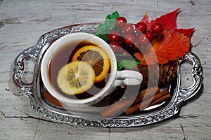 Hot tea with lemon in autumn and winter evenings - a festive table