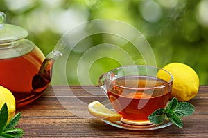 hot tea with lemon and mint in glass cup