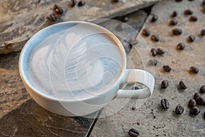 Hot tea and milk mixture Clitoria ternatea. Served in a white coffee cup