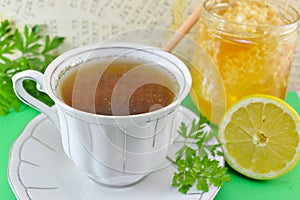 Hot tea with parsley, lemon and honey