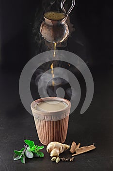 Hot Tea pouring from kulhad(earthen pot/mud pot) photo