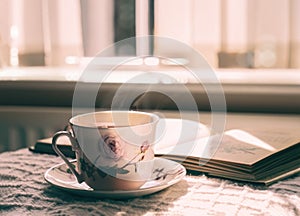 Hot tea with steaming in cinematic tone, Still life cuppa tea with steam on a coffee table with morning light shining from window,