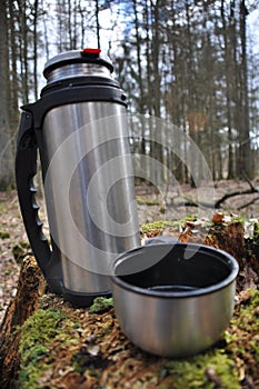 Hot tea in thermos for a walk in the woods