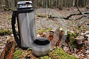 Hot tea in thermos for a walk in the woods