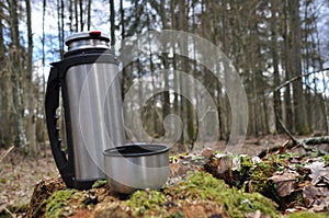 Hot tea in thermos for a walk in the woods