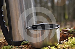 Hot tea in thermos for a walk in the woods