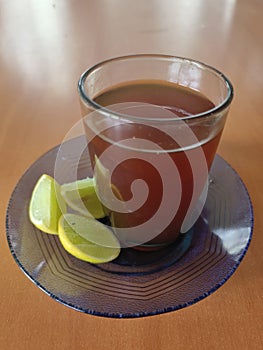 hot tea to which lime is added as a remedy to relieve fever photo