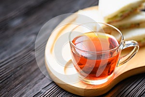 Hot Tea with Tuna Sandwich on wooden plate