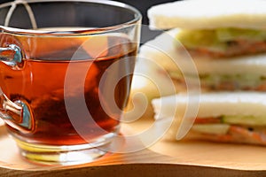 Hot Tea with Tuna Sandwich on wooden plate