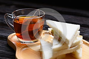 Hot Tea with Tuna Sandwich on wooden plate