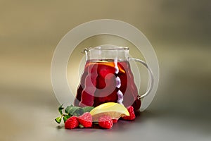 Hot tea wild berries in a glass teapot