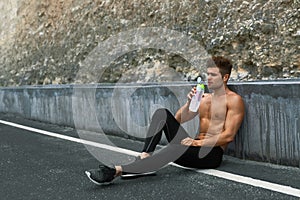 Hot Thirsty Man Drinking Water Drink After Running Outdoors. Sport