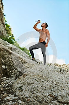 Hot Thirsty Man Drinking Water Drink After Running Outdoors. Sport