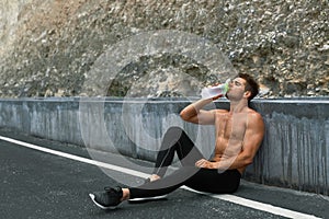 Hot Thirsty Man Drinking Water Drink After Running Outdoors. Sport