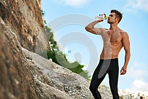 Hot Thirsty Man Drinking Water Drink After Running Outdoors. Sport