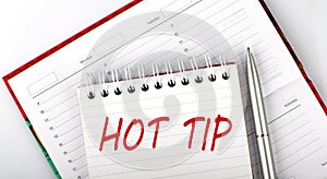 HOT TIP text on notebook on the diary,business