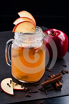 Hot Toddy Cocktail with apple, Lemon, Rum On Dark Background