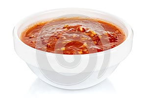 Hot tomato sauce with spices and salt in a small white ceramic round bowl isolated on white background