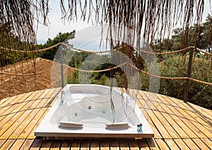 Hot tub in the hotel room suite balcony with sea view. Summer day honeymoon romantic luxury resort vacation place