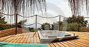 Hot tub in the hotel room suite balcony with sea view. Summer day honeymoon romantic luxury resort vacation place