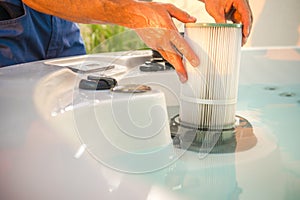 Hot Tub Technician Removing Water Filter and Performing Scheduled Garden SPA Maintenance