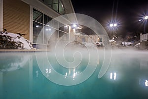 Hot tubs and ingound heated pool at a mountain village in winter