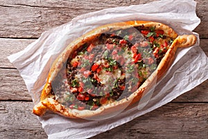 Hot Turkish pizza pide close up on the table. horizontal top vie