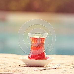 Hot turkish tea outdoors near water. Turkish tea and traditional