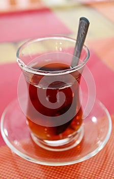 Hot Turkish Tea in Tulip-shaped Glass on Colorful Table