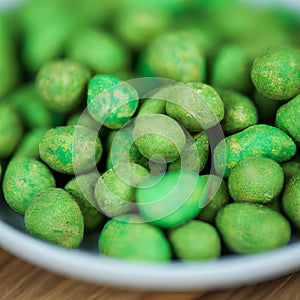 Hot Wasabi Peanuts. Wasabi coated peanuts close-up. Green spicy Japanese snack