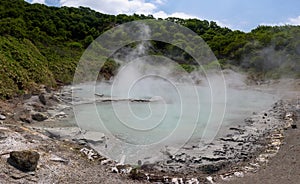 The hot water of Oyunuma pond in the volcanic landscape of Hell Valley Jigokudani