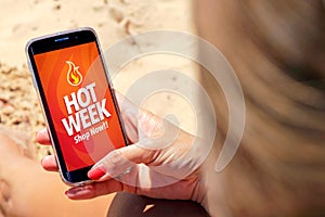 Hot Week advertising on the screen of mobile phone. photo