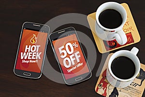 Hot Week 50% Off discounts. Advertising, Special Offer. Two cell phones and two coffee cup over the table. Marketing, Internet bus