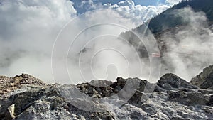 Hot white smoke cloud from hot crater in close distance shot