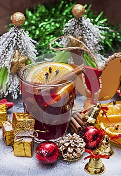 Hot wine (mulled wine) with spices on wooden background. Selective focus.