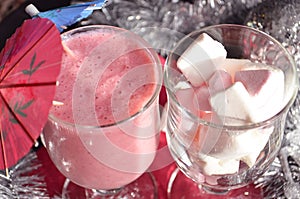 Hot winter drink with candies, Christmas or New Year decorations, dark background, rustic style, colored marshmallows
