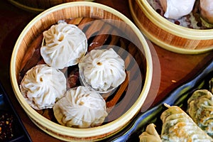 The hot xiao long pao in bamboo steaming basket - famous chinese food concept