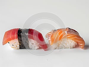 Hotate Sushi Roll and salmon and otoro sashimi with a white backdrop. Sushi with salmon and cucumber on a plate.?