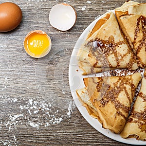 Hotcakes with chocolate on plate