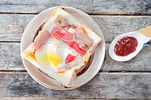 Hotdog and crab stick in a hole of a slice of bread
