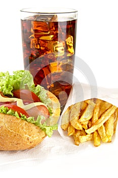 Hotdog with french fries on napkin with glass of cola