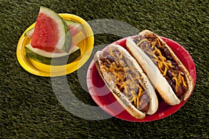 Hotdog sandwiches and watermelon