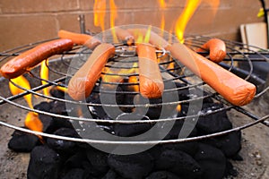 Hotdogs cooking on grill