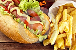 Hotdogs ready-to-eat with fresh salad on wooden desk