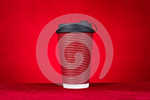 A hotdrink paper cup on a red background horizontal composition