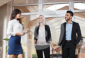 Hotel Administrator Welcome Business Couple In Lobby, Businesspeople Group Man And Woman Guests Arrive