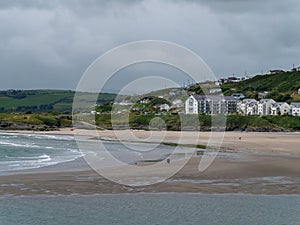 A hotel on the Atlantic Ocean. Inchydoney beach at low tide. Landscape. White concrete building near body of water. Inchydoney