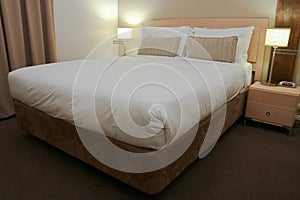 Hotel bedroom with bed and side lamps