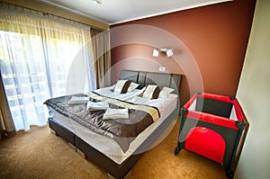 Hotel bedroom with playpen