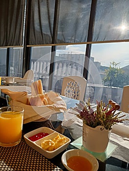 Hotel breakfast. Bread, jam butter orange juice.